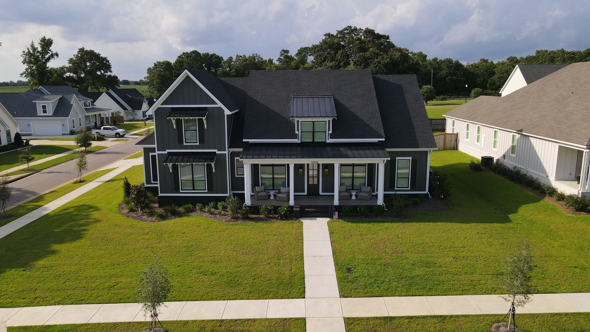 Two-story home with board and batten siding and a new roof